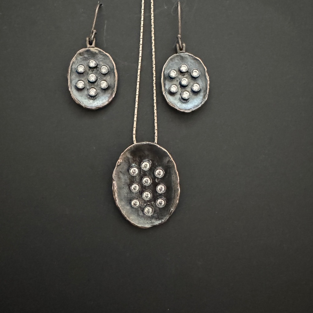 Matching earrings and pendant. Charcoal grey disks with sparkle.